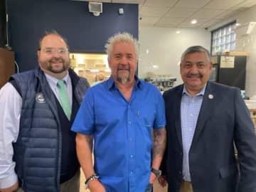 Celebrity chef Guy Fieri (center) is pictured with Port Chester Mayor Luis Marino (right) while visiting Rinconcito Salvadoreño during the filming of an episode of "Diners, Drive Ins, and Dives."