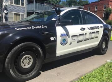 Hartford police found a woman in her 20s shot numerous times in the passenger seat of a vehicle.