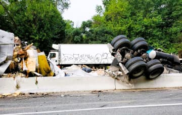 The driver was initially entrapped but climbed out on his own after his northbound rig went over the divider near the Route 202 exit at Mountainside Avenue at 8:43 a.m. Sept. 8, Mahwah Police Chief Timothy O'Hara said.