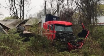 A tractor-trailer driver escaped injury during a rollover crash.