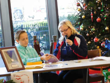 U.S. Olympian Elaine Zayak and her son Jack read to the crowd at the Lodi Memorial Library Saturday.
