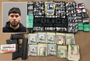 Police arrested Angel Carrasquillo after narcotics detectives and federal agents raided his home and found drugs, cash, and an unlicensed gun, authorities said.