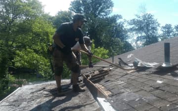 Manuel Rodriguez works to replace the roof of a West Milford home.