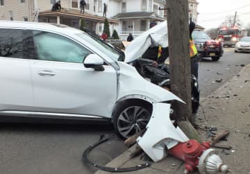 Airbags deployed when the Buick Enclave hit the hydrant and pole in Ridgewood in front of an audience of roofers.