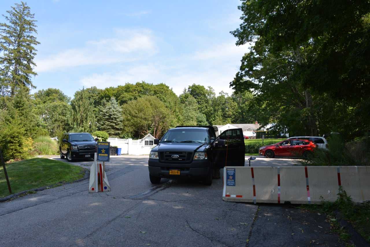 The end of Old House Lane in Chappaqua, which has been closed off by the Secret Service due to security reasons. Hillary Clinton, who lives on the road, is the Democratic presidential candidate. Both of the Clintons' properties are in the background.