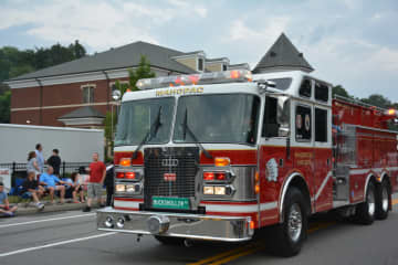 A Mahopac firetruck is driven through the fire department's dress parade.