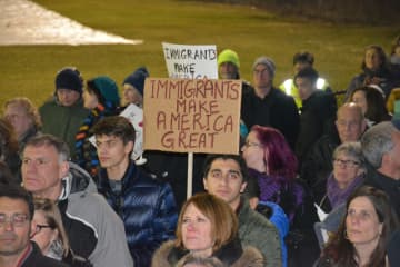 Demonstrators at an interfaith vigil in Chappaqua protest President Donald Trump's ban on admitting refugees.