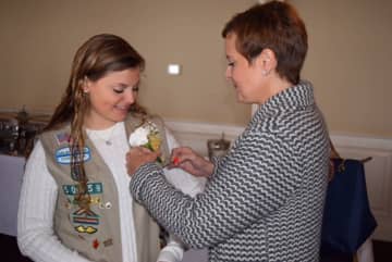Grace Herrick gets her corsage pinned by her mother, Ana Cristina Herrick, at a luncheon celebrating the centennial of the Girl Scout Gold Award. Herrick, of Newtown, is a recipient of the Gold Award.