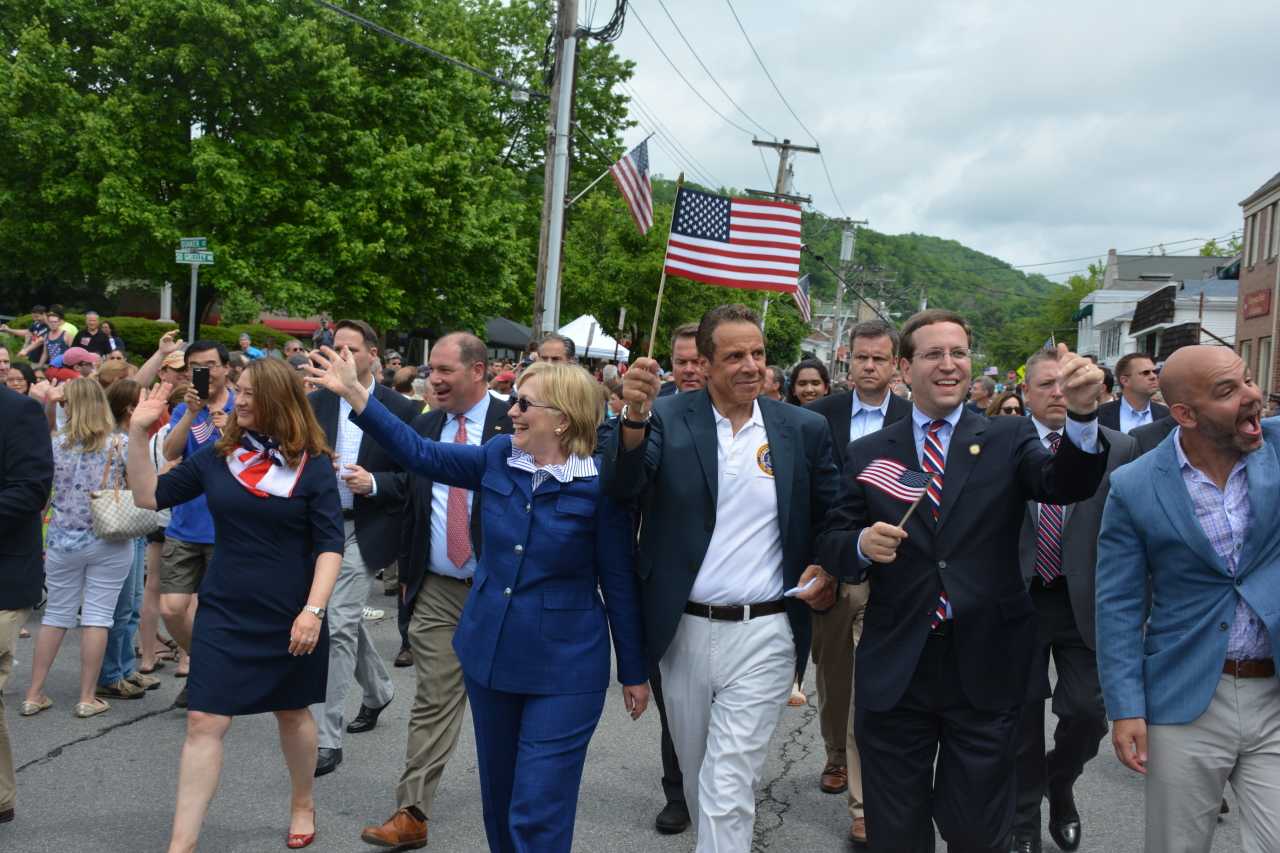 Gov. Andrew Cuomo, center, marches with fellow Town of New Castle resident, Chappaqua's Hillary Clinton, far left, in downtown Chappaqua for the 2016 Memorial Day parade.