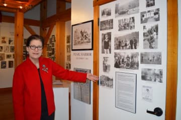 Executive Director Susan Gunn Bromley explains the Weston Historical Society's latest exhibit, "Memories of World War II."