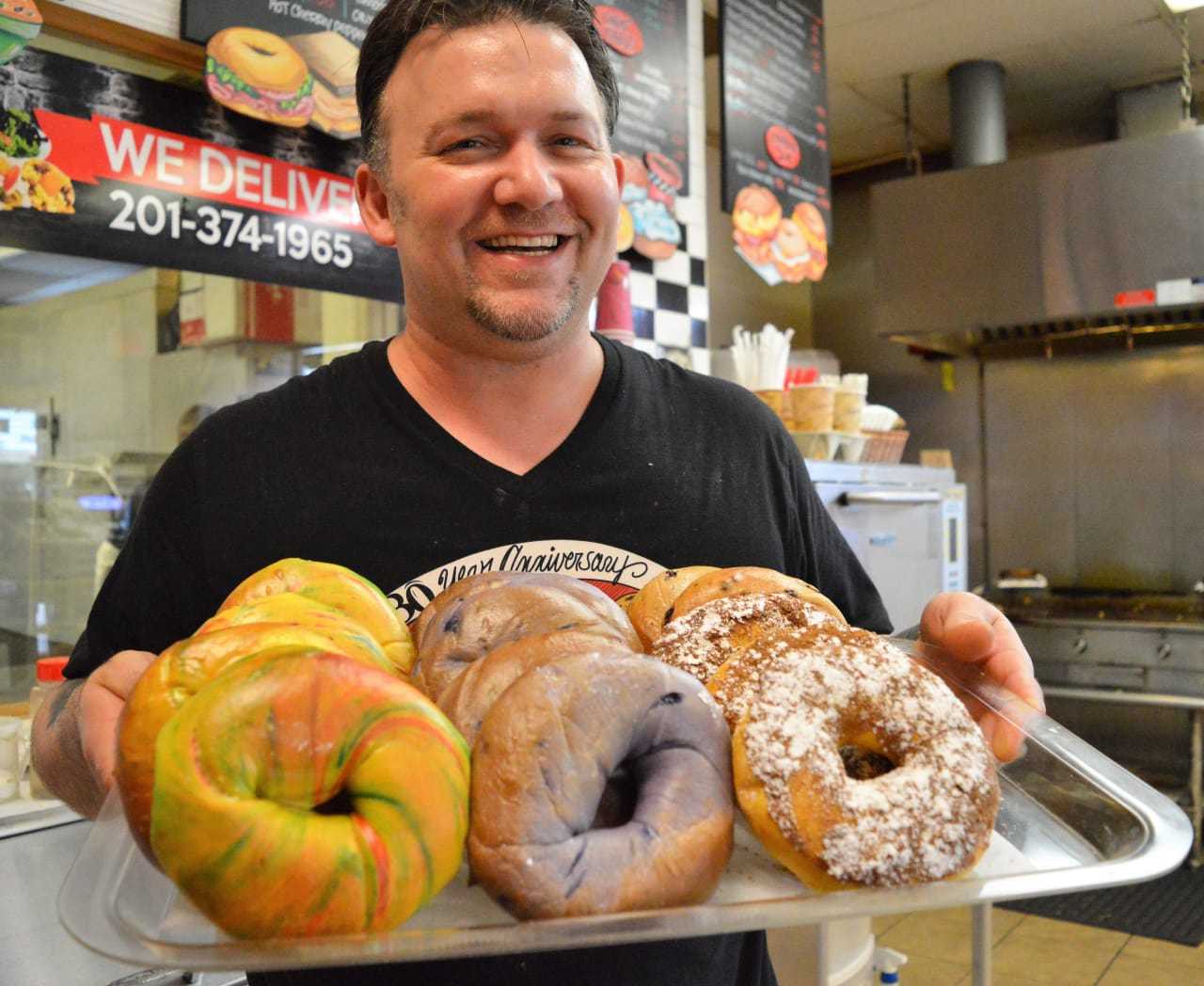 Marc Windler of Bakin' Bagels with a tray of fresh-baked bagels.