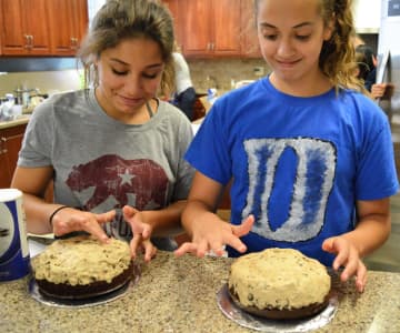 Students work with a cookie dough filling as part of making a ganache cake.