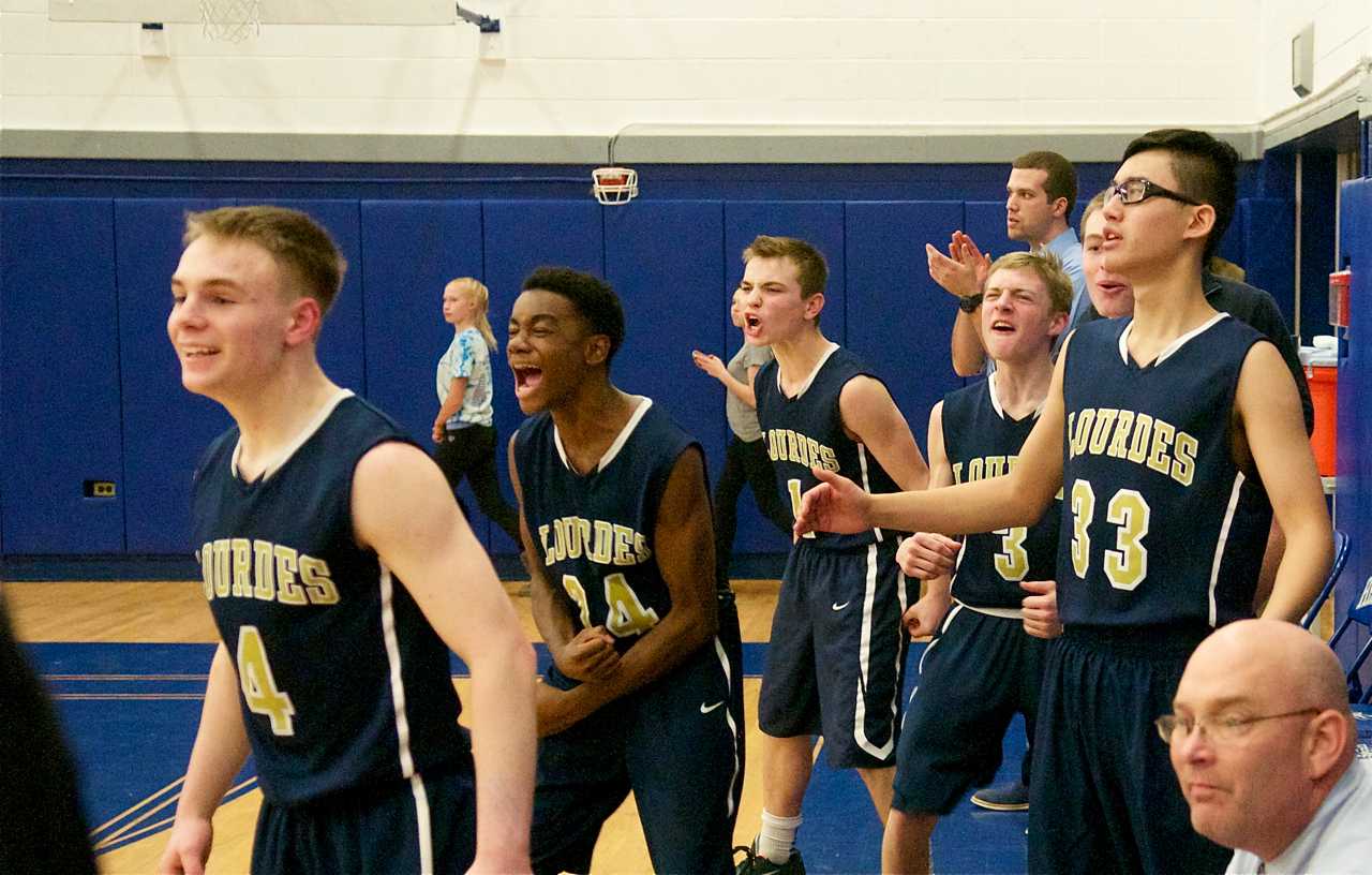 The Lourdes bench likes what it sees on the court.