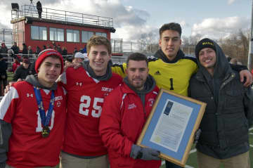 Coach Brian Lanzetta and captains from the 2016 Class A state championship boys soccer team at Saturday's state championship celebration.