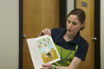 An EverWonder staff member reads to children during 'Story Lab."