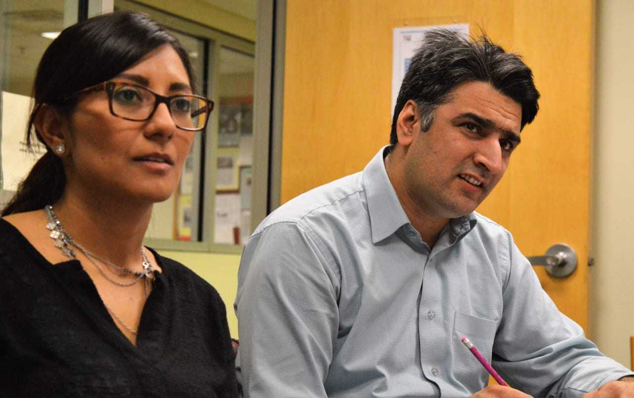 Frieda Alvarenga of El Salvador and Aitzaz Ashraf of Pakistan follow along at an English as a Second Language class at Bergenfield Public Library.