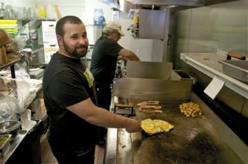 At the grill: Omelettes, bacon and home fries are some of the most popular items at Eggs and Company.