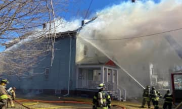 Smoke pours out of a multi-family home at 11 Arch Street in North Brookfield