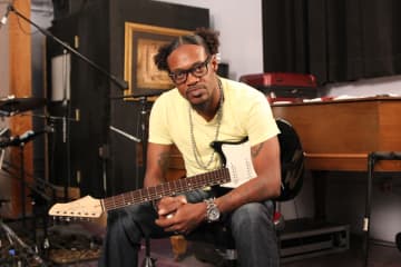 Eric Gales holds a John Page Classic Ashburn guitar.