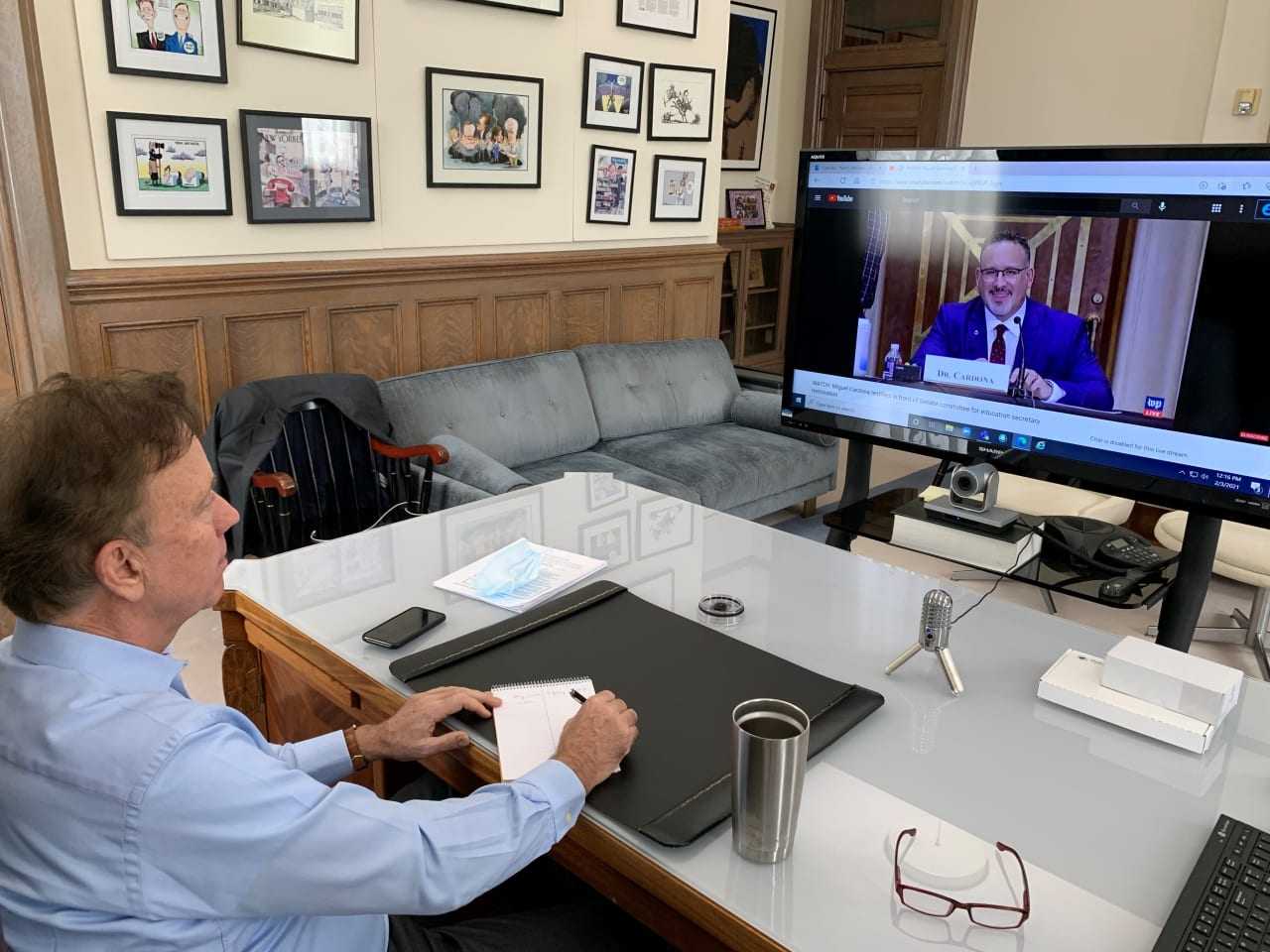 Connecticut Gov. Ned Lamont watching Education Commissioner Miguel Cardona in front of the Senate.