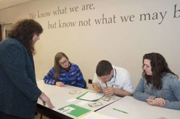 Professor Julie Norflus-Good observes  Ramapo College students work with a student from The Forum School.