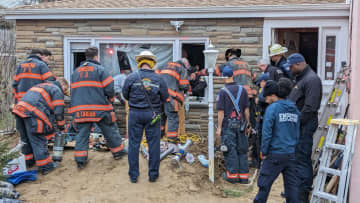 Members of the Yonkers PD and the city's fire department conduct a rescue operation to free a person trapped in a trench at 15 Frederic Place.