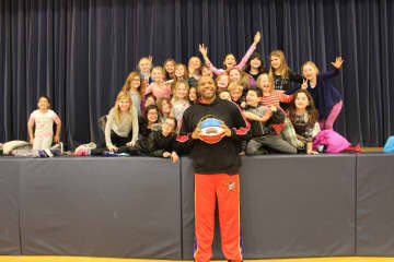 "Big Mike" of the Harlem Wizards poses for a photo with Katonah Elementary School students.