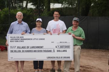 Jim Hanley, president of Fields for Kids, Bill Nachtigal, president of Larchmont Mamaroneck Little League, and state Assemblyman Steve Otis present a check for $1.6 million to Larchmont Mayor Lorraine Walsh.