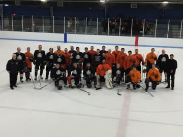 Alumni from Mamaroneck hockey programs on the ice at Hommocks Arena on Monday.