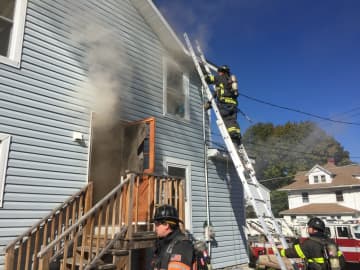 Danbury firefighters tackle a blaze at 23 McDermott St. on Friday afternoon.