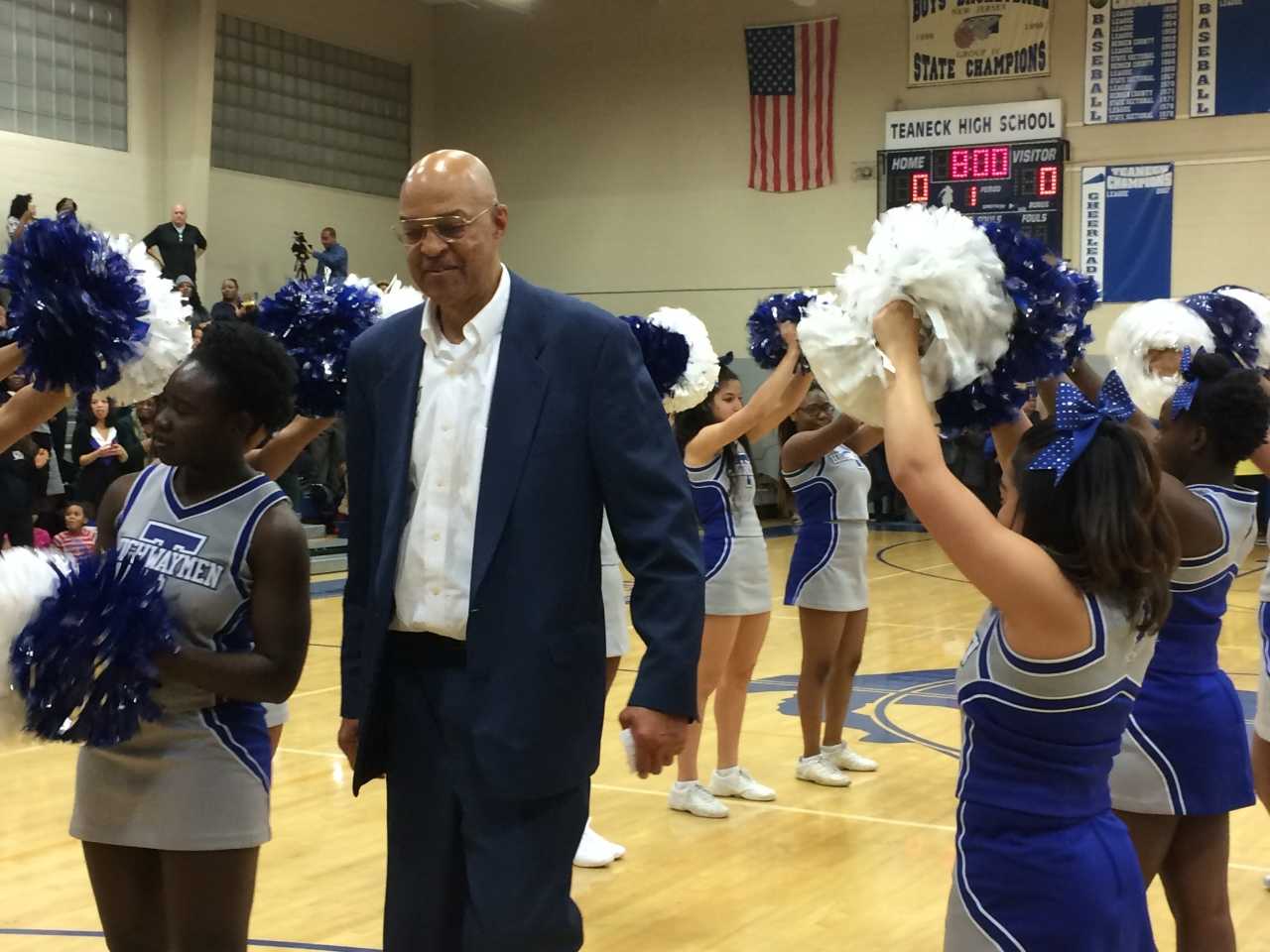 Longtime Teaneck basketball coach Curtis March walks through a wave of supporters at a court-naming ceremony in his honor Thursday, Jan. 7.