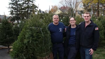 Capt. David Oldewurtel with two of his children, Kaitlyn and Andrew, at the Dumont Volunteer Ambulance Corps Christmas tree sale.