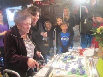 Clara Fontana cuts the cake at her 107th birthday party.