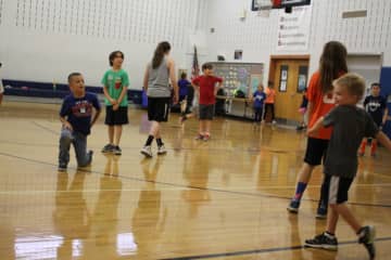 Students play "octupus," a tag game, at the Grant Elementary School sports clinic. 