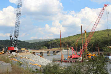 A barge sits on the Wanaque Reservoir as a new bridge first suggested in 2001 begins to materialize.