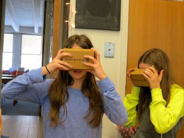 From left, John Jay Middle School students Aidan Summer and Julia D’urso use Google Cardboard devices for a virtual-reality tour of Egypt.