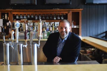 Matt Van Allen stands behind the bar at the Old Forge Spirits & Pub in Ringwood.