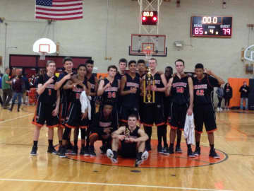 The Mamaroneck Tigers boys' basketball team pose with the Tigers Tournament trophy.