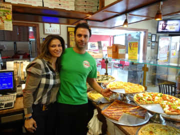 Adisa Feratovic, left, helps her fiancé, Gaetano Buttitta, right, run Pizza Mania in Garfield.
