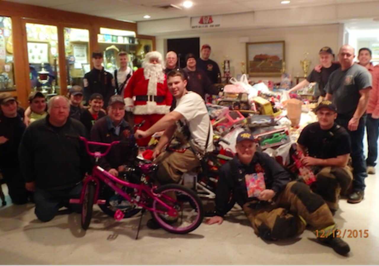 Santa and his smoke eating elves along with the toys that were collected for Toys 4 Kids by White Hills Fire Company.