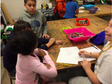 Children from New Rochelle's Boys and Girls Club are brainstorming and sketching designs for containers to protect their egg from a fall of more than 20 feet.