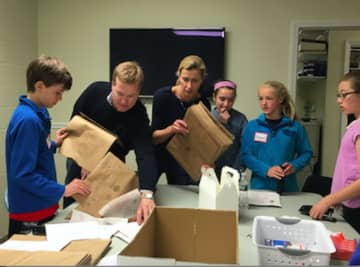 Volunteers prepping grocery bags for Postal Service Food Drive at Person-to-Person during  Kyle A. Markes Day of Service on April 16. The organization received a $10,000 grant from Pepperidge Farm, a subsidiary of Campbell Soup Company.