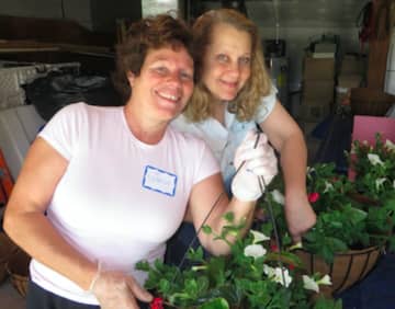 Twenty-seven New Canaan Beautification League members recently gathered together at the home of Libby Butterworth. Armed with trowels and wire cutters, they assembled the 207 hanging baskets now adorning lampposts throughout town.