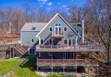 A magnificent 5-bedroom Colonial in Pound Ridge offers decks on three levels of the house.