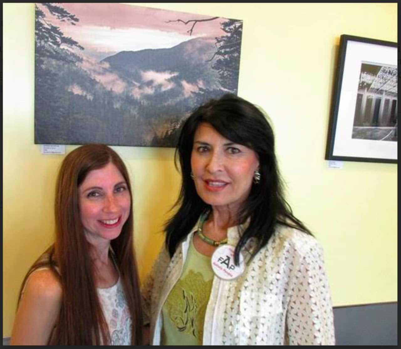 FAP founder Brita Darany von Regensburg and photographer Danielle O'Brien show off the artwork for sale at Meli-Melo Creperie & Juice Bar in Greenwich.