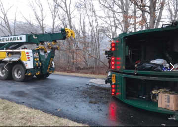 The garbage truck rolled over at around 5:30 a.m. Thursday.
