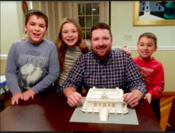 Ridgefield architect Keith Olsen with his three children, from left, Benjamin, Kaleigh and Miles.  Olsen built a miniature model of Grand Central Terminal from Legos.