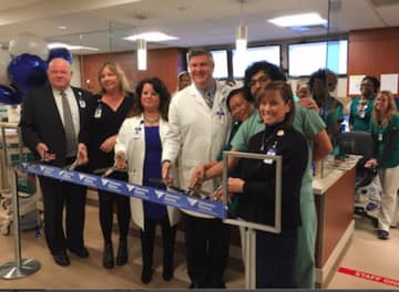 Norman Roth (left), president of Greenwich Hospital, and Susan Brown. RN, MSN (right), executive vice president for Operations, flanked by Emergency Department staff at a ribbon cutting event to celebrate a multi-million dollar renovation.