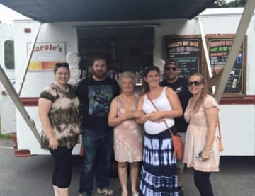 Owner Carole Crusco, 79, center, outside her popular Hyde Park food truck called Carole's HotDogs.