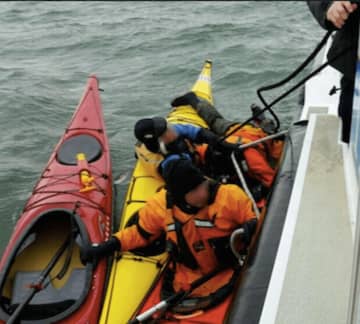 A kayaker is rescued by officers with the Greenwich Police Department's marine unit after falling out of his kayak Saturday afternoon near Great Captain's Island.